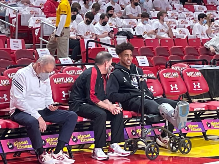 Indiana guard Rob Phinisee smiles on the bench with his scooter and boot prior to Saturday’s game at Maryland.